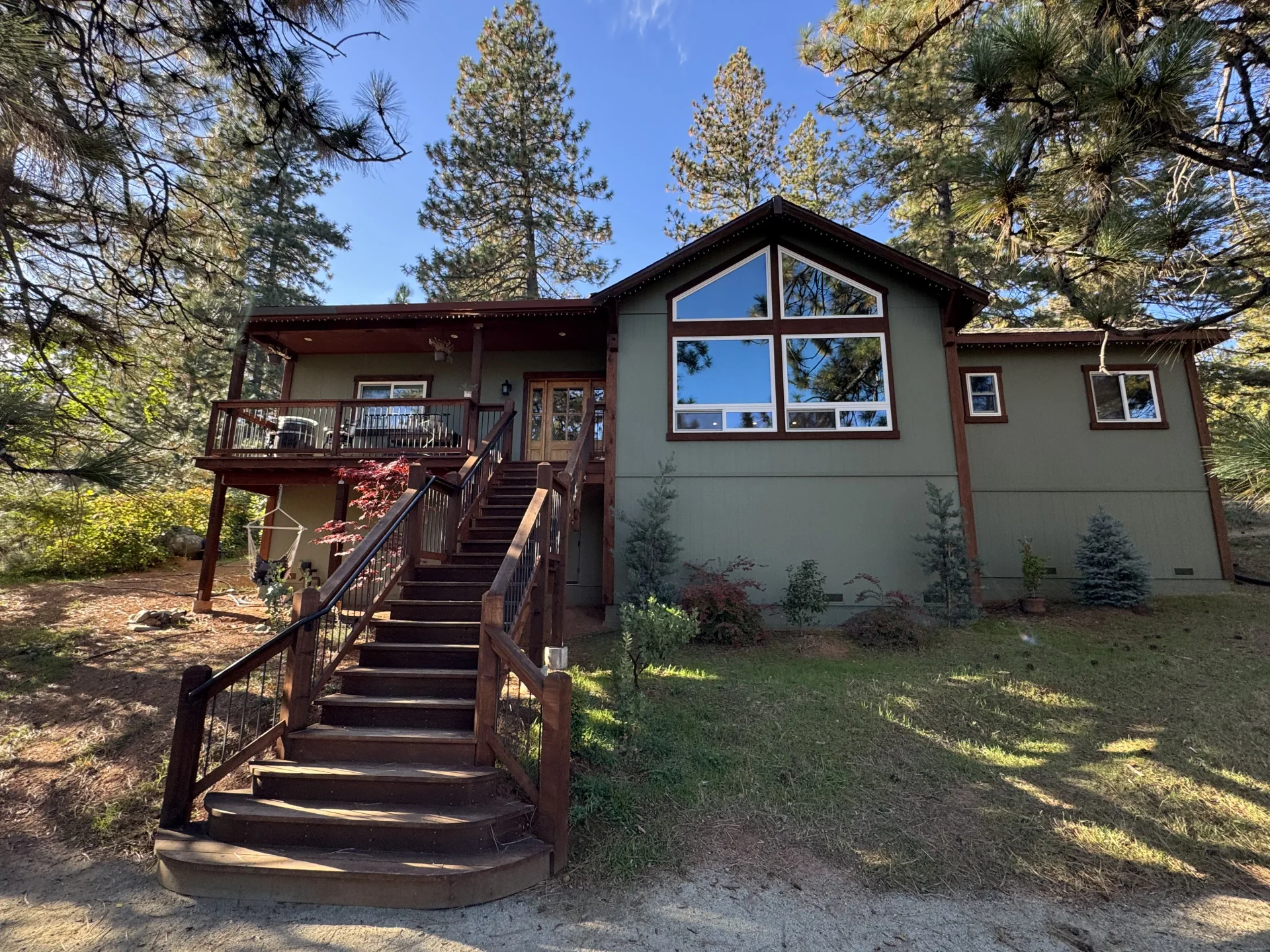 Two-story home exterior with deck and staircase built by Monument Construction in Colfax, CA